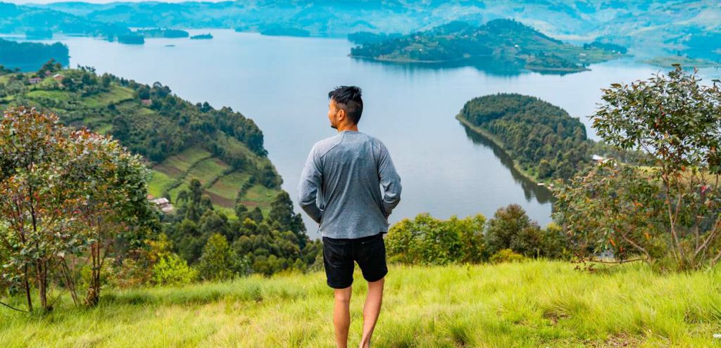 A visitor enjoying moments at the picturesque Lake Bunyonyi in Western Uganda. Credit: bucketlistly.blog